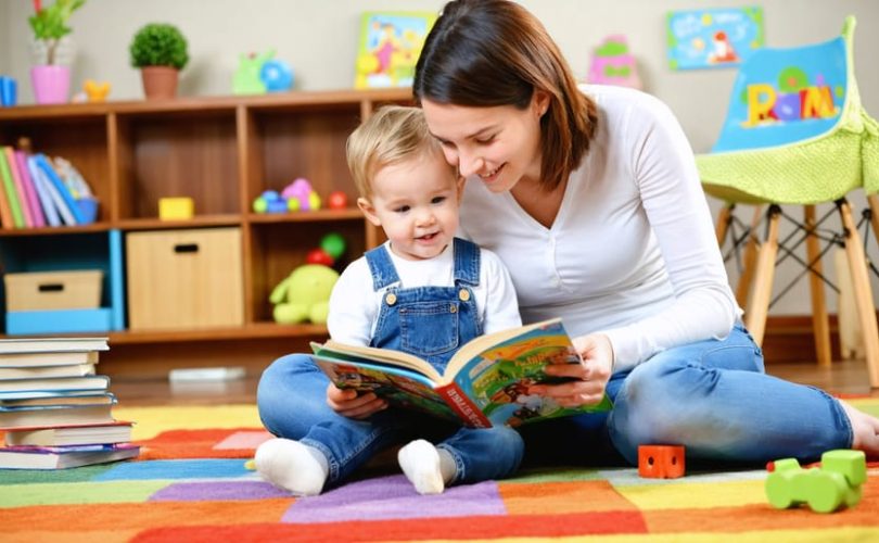A nurturing scene of a parent reading a picture book to a young child on a carpet, surrounded by educational toys, capturing a moment of bonding and learning.