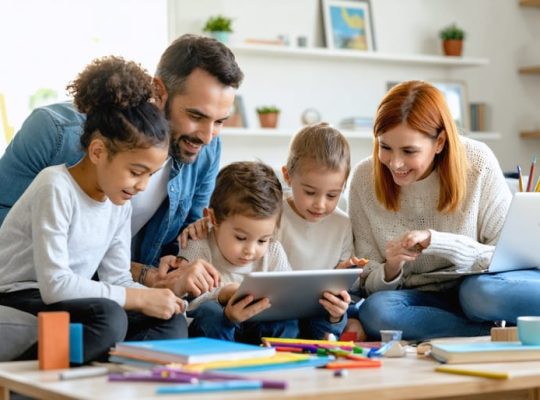 A family in a living room enjoying digital educational content together on various devices, surrounded by books and games indicating a balanced lifestyle approach to screen time.