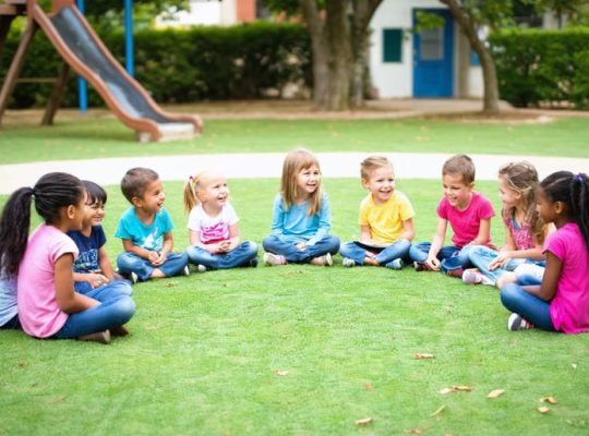 A group of children of diverse backgrounds sitting in a semicircle on a grassy field, actively engaged in storytelling and practicing communication and active listening skills with the guidance of an adult.