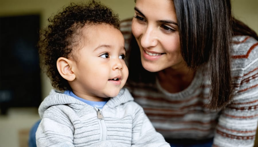 Parent and child sitting together on a couch, demonstrating active listening techniques with warm body language