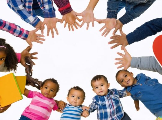 Diverse group of children from different cultural backgrounds holding hands in a circle, symbolizing unity and support in addressing mental health care disparities.
