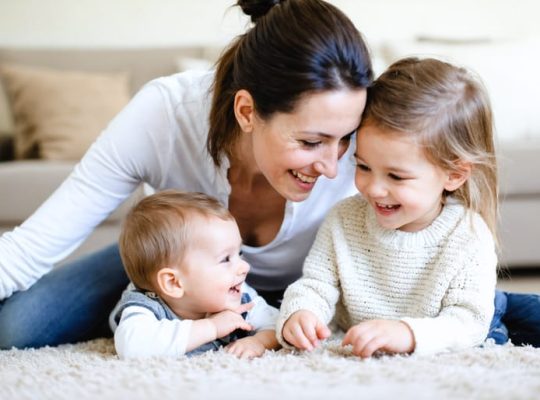 Parent and child sharing a meaningful interaction, symbolizing a nurturing environment that fosters emotional intelligence and strong family bonds.