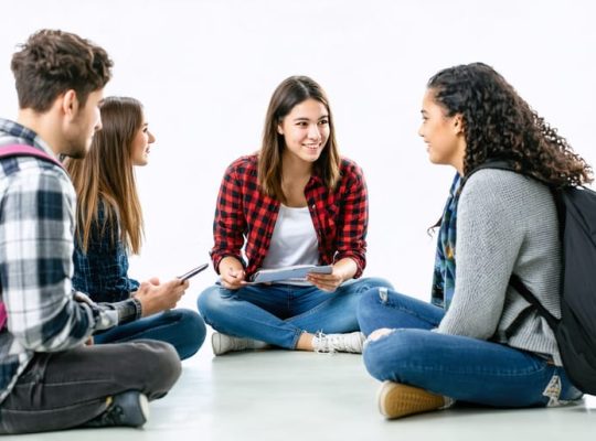A diverse group of students and a school counselor in a supportive therapy session within a welcoming school environment, representing the importance of accessible mental health services.
