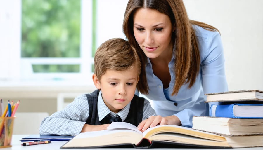 Teacher standing beside student's desk, maintaining professional distance while explaining coursework