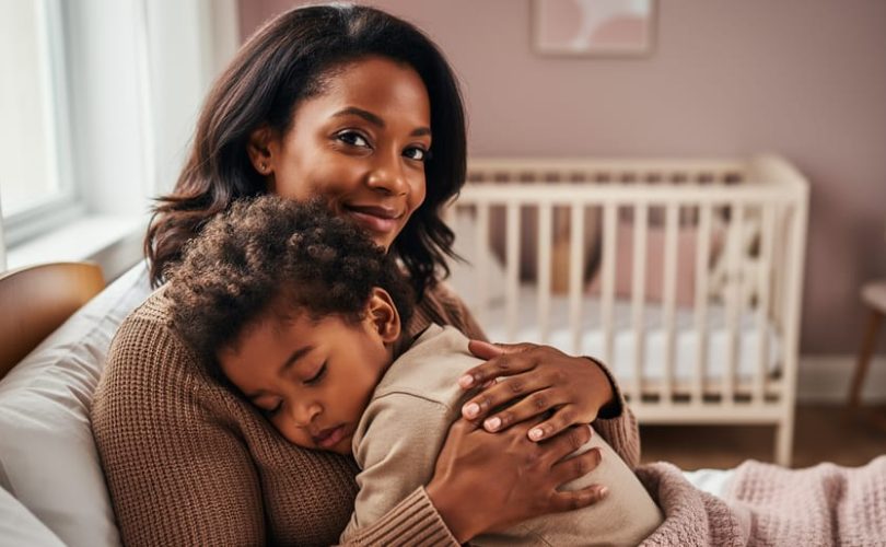 Parent holding a child close during a soothing moment, conveying emotional security and nurturing attachment.