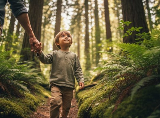 A child walking beside a parent on a mossy forest path, surrounded by tall trees and soft green light filtering through leaves.