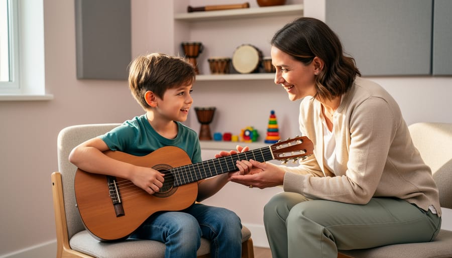 A child sits with a music therapist at a therapy table, holding a drumstick above a hand drum.